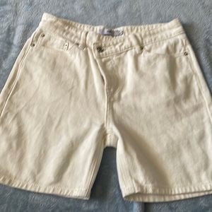 Cream denim shorts.